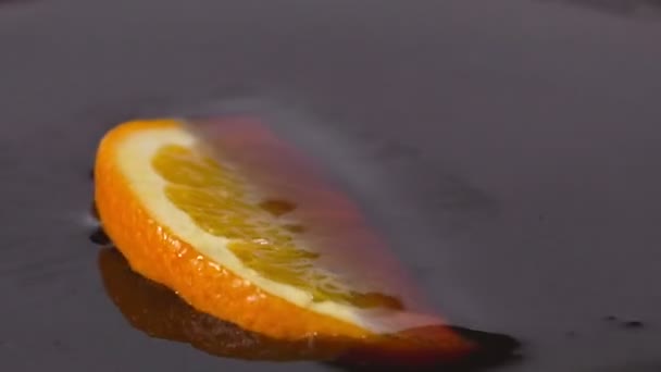 Close-up van een heerlijke oranje segment vallen chocolade siroop — Stockvideo