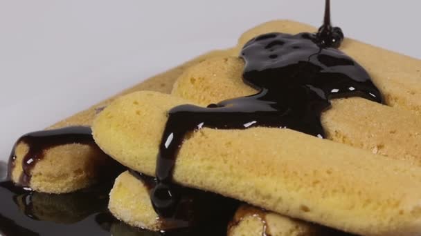 Pouring delicious chocolate syrup over ladyfingers biscuits — Stock Video