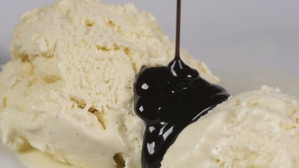 Pouring delicious chocolate syrup over ice-cream — Stock Video