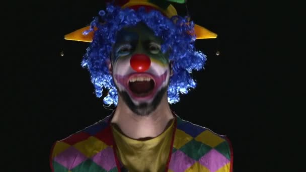 Ung lustiga clown göra skrämmande grimaser och skrattar — Stockvideo