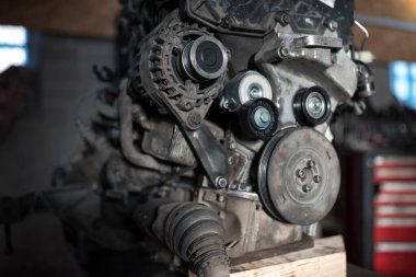 Car engine removed from the car for inspection in the garage.