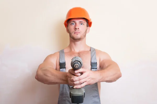 Man holding a screwdriver in the two arms — Stock Photo, Image
