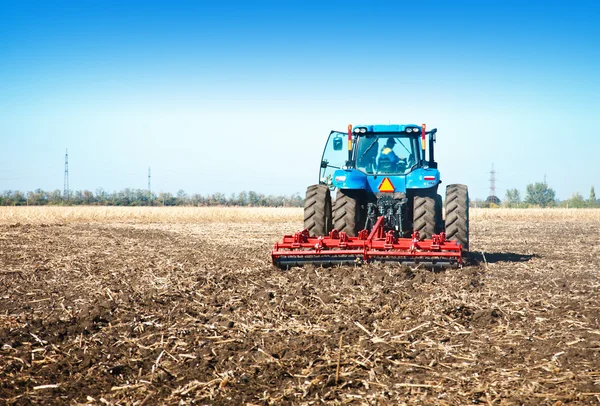 Blue tractor in the field — Stock Photo, Image