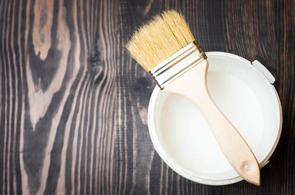 Bank paints and brush on a wooden background — Stock Photo, Image