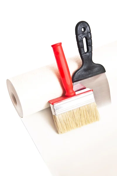 Brush, spatula and roll of wallpaper — Stock Photo, Image