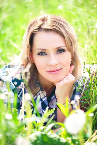 Portrait of a beautiful attractive woman in the grass — Stock Photo, Image