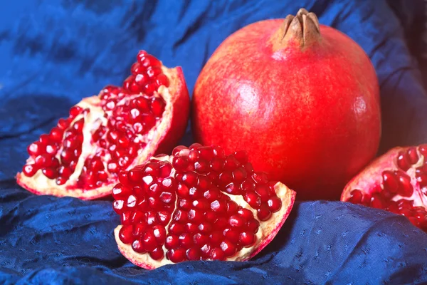 Juicy ripe pomegranates on dark background — Stock Photo, Image