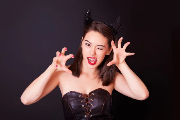 Young cheerful woman with and horns on her head — Stock Photo, Image