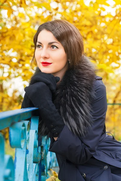 Portrait of a beautiful young woman in black coat — Stock Photo, Image