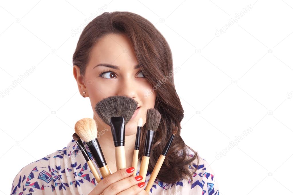 Girl makeup artist with brushes