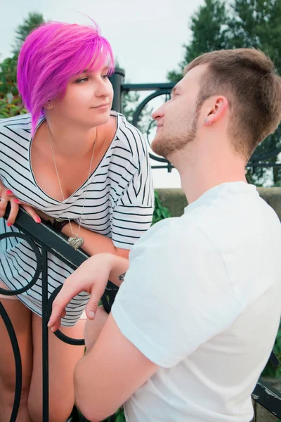 Boy and girl standing near a railing — Stock Photo, Image