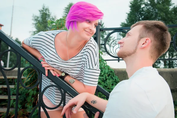 Boy and girl standing near a railing — Stock Photo, Image