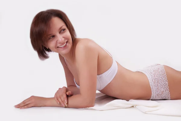 Menina em lingerie sobre fundo branco — Fotografia de Stock