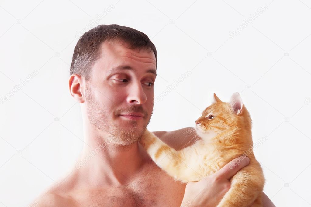 Man holding a cat on his hands
