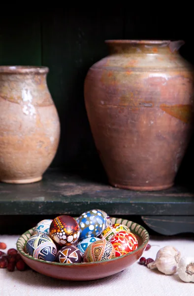 Still life with jug and mix of eggs in the traditional designs — Stock Photo, Image