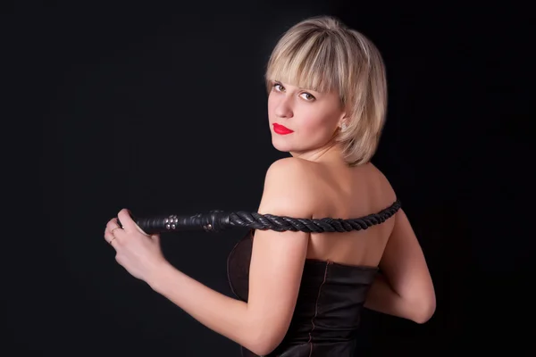 Portrait of attractive woman with a whip in his hand — Stock Photo, Image
