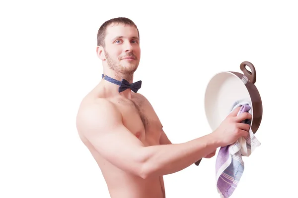 Attractive man with a towel wipes clean pan — Stock Photo, Image