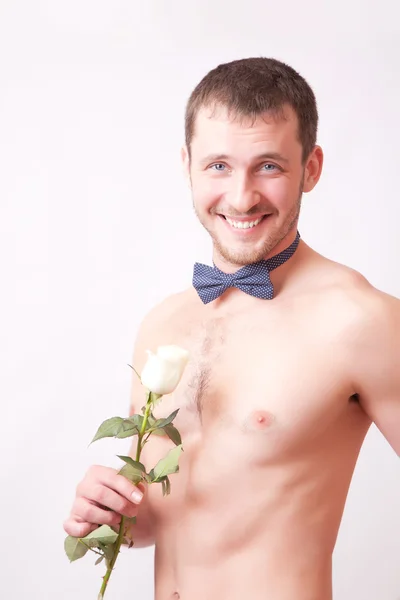 Cheerful muscular man posing with a rose — Stock Photo, Image