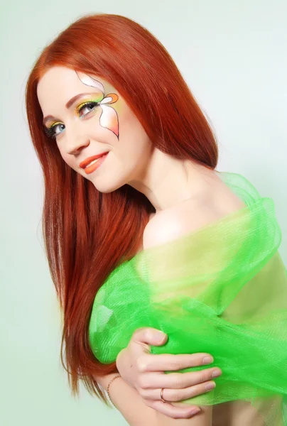 Portrait of beautiful red-haired girl with flower painted on his face — Stock Photo, Image