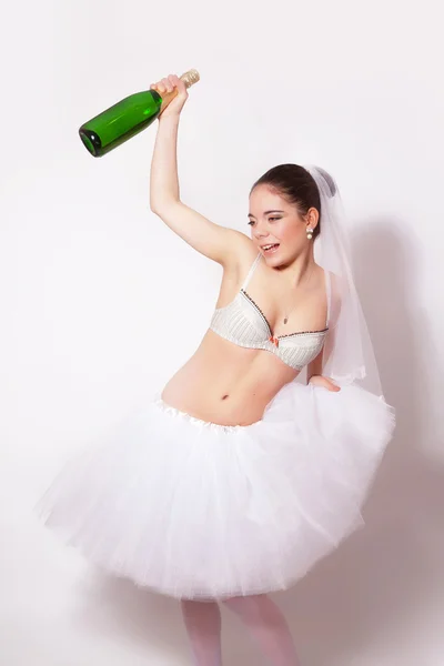 Merry bride with a bottle of champagne in hand — Stock Photo, Image