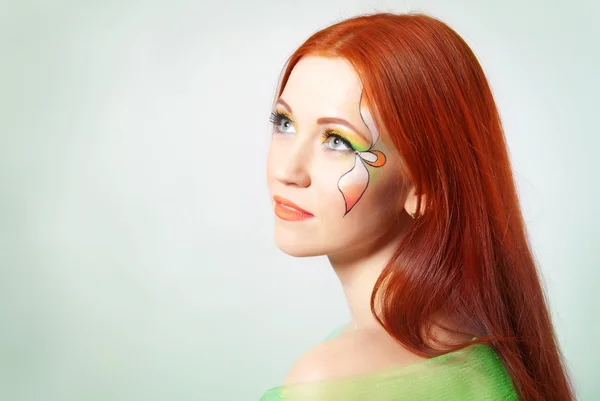 Portrait of red-haired girl with flower painted on his face — Stock Photo, Image