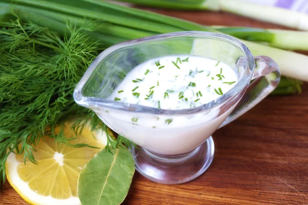 Creamy sauce with herbs on a table — Stock Photo, Image