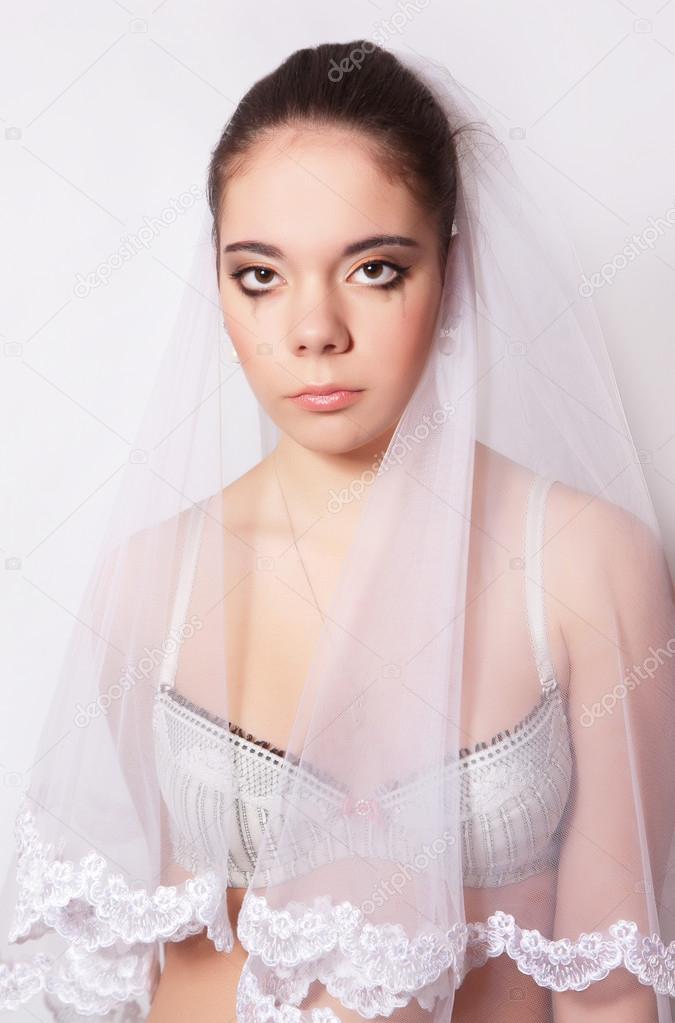 Portrait of a beautiful bride crying
