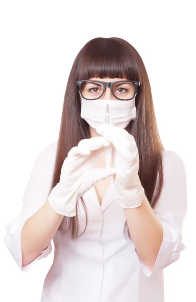 Beautiful young doctor in medical robe holding syringe — Stock Photo, Image