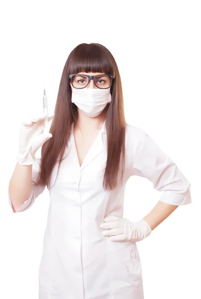 Beautiful young doctor in medical robe holding syringe — Stock Photo, Image