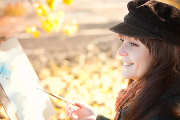 Portrait of a young beautiful woman with a brush in her hand — Stock Photo, Image