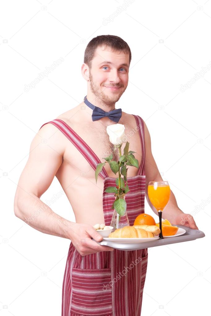 Attractive man in an apron with breakfast