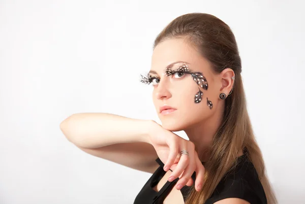 Beautiful woman with big eyelashes and face-art — Stock Photo, Image