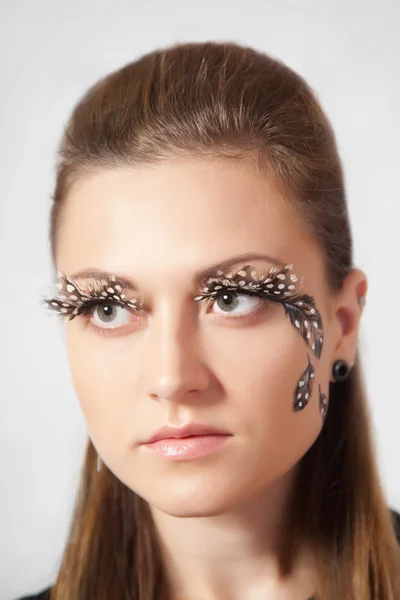 Beautiful woman with big eyelashes and face-art — Stock Photo, Image