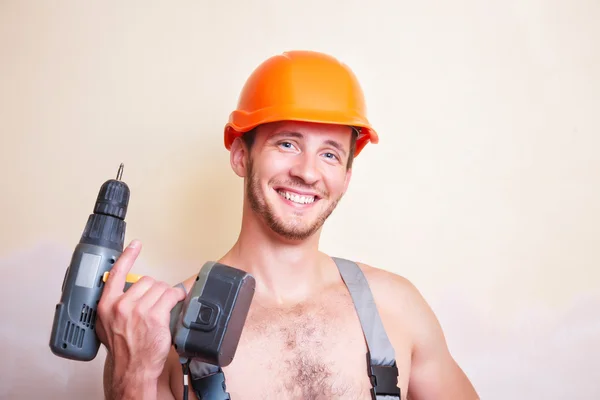 Man in overalls with a screwdriver — Stock Photo, Image