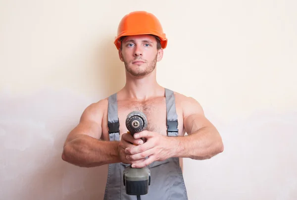 Man holding a screwdriver in the two arms — Stock Photo, Image