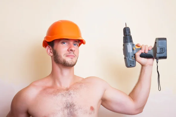 Man in helmet with a screwdriver — Stock Photo, Image
