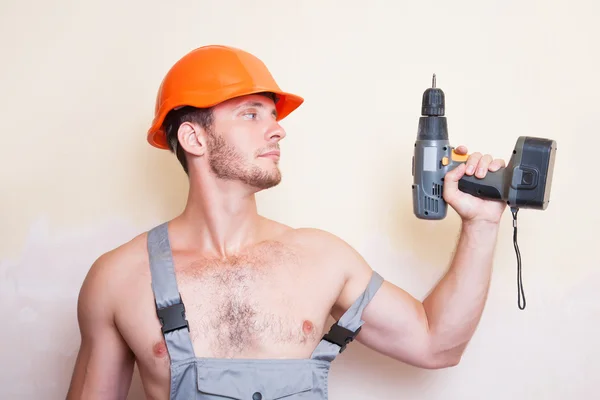 Man in overalls with a screwdriver — Stock Photo, Image