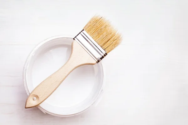 Bank paints and brush on a wooden background — Stock Photo, Image