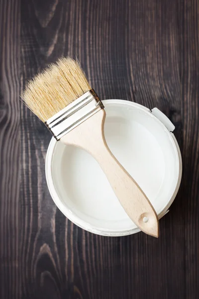 Bank paints and brush on a wooden background — Stock Photo, Image