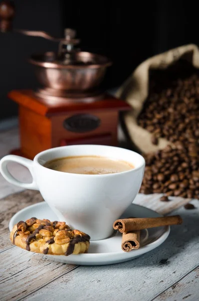 Coffee, roasted beans, mill grinder and some sweets — Stock Photo, Image