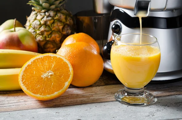 Vers sap en juicer. Foto op houten achtergrond — Stockfoto