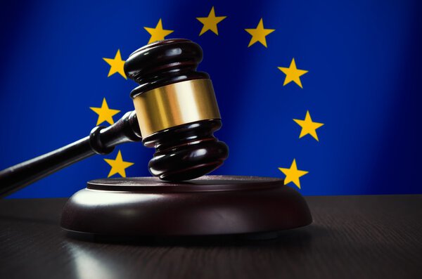 Wooden gavel with European Union flag in background