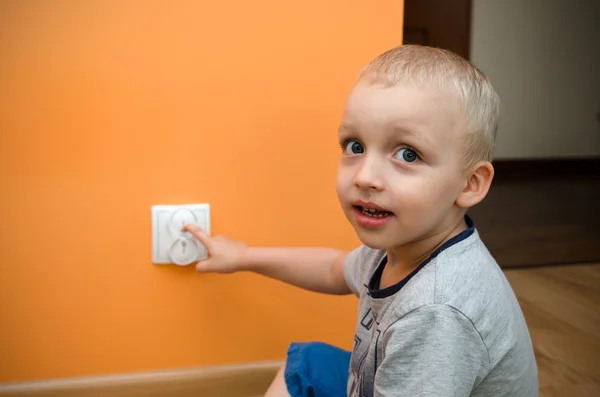 Niño cerca del enchufe . — Foto de Stock