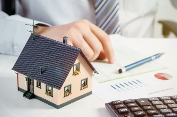 Uomo d'affari calcolare il costo di costruzione e manutenzione della casa — Foto Stock