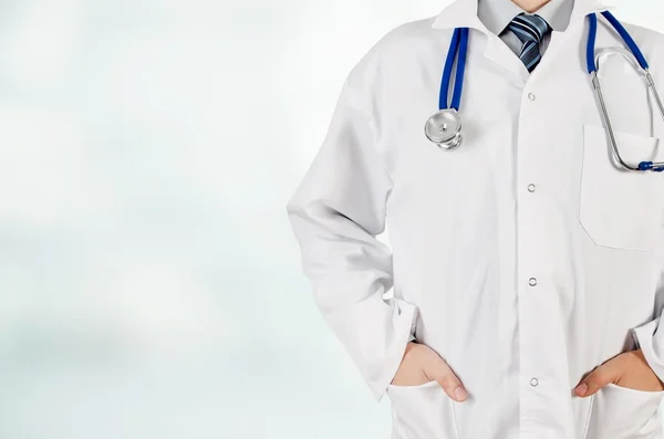 Doctor with hands in pocket on blurred background. Copyspace medical conception — Stock Photo, Image