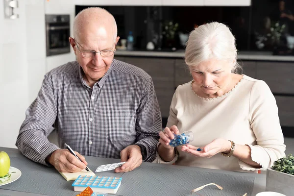 Senior couple are taking medication. Health and medicine concept