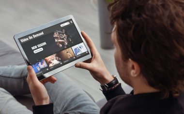 Talep üzerine video, film yayını, tabletli adam video servisi kullanıyor.