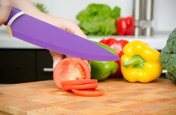 Cook preparing food, cut the tomato into slices — Stock Photo, Image