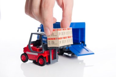 Hand taking boxes from forklift toy. Concept of international fr