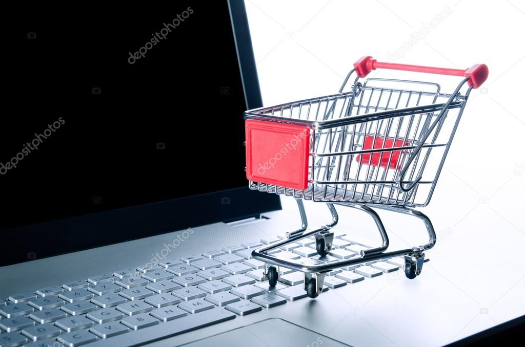 Internet shopping concept. Basket on laptop keyboard